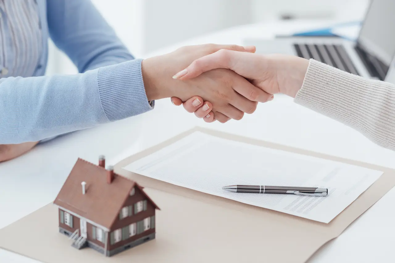 Real Estate Broker and Customer Shaking Hands 